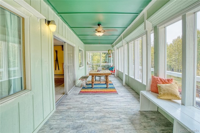 sunroom / solarium with a healthy amount of sunlight and ceiling fan