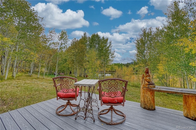 deck featuring a yard and a water view