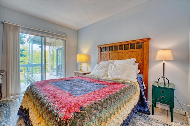 bedroom with a textured ceiling and access to outside