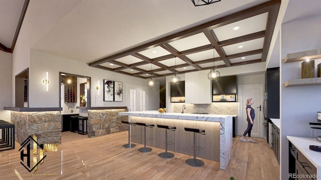 7969 Forest Keep Cir, Parker, CO 80134 - kitchen with coffered ceiling, light wood finished floors, tasteful backsplash, beam ceiling, and a kitchen breakfast bar