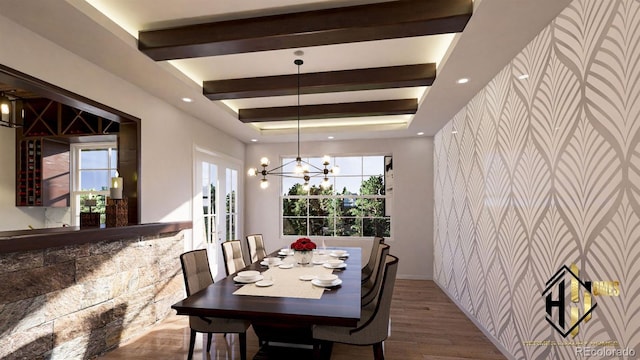 7969 Forest Keep Cir, Parker, CO 80134 - dining space featuring an accent wall, wood finished floors, a chandelier, healthy amount of natural light, and wallpapered walls