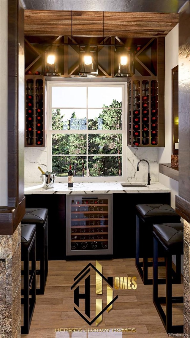 7969 Forest Keep Cir, Parker, CO 80134 - indoor wet bar featuring wine cooler, wood finished floors, and decorative backsplash