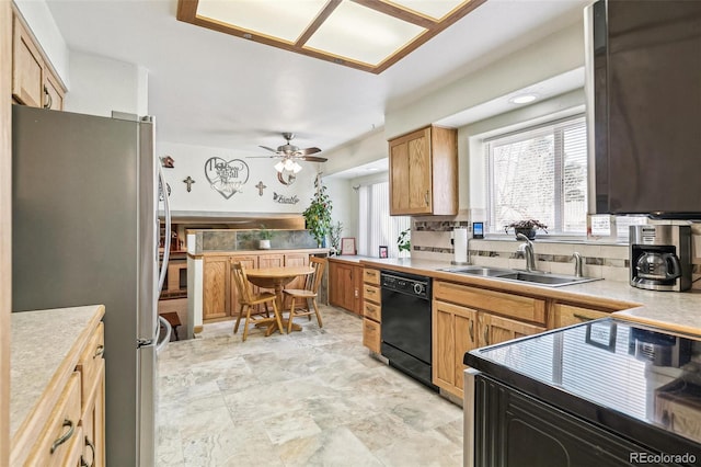 kitchen with black appliances, light countertops, ceiling fan, and a sink