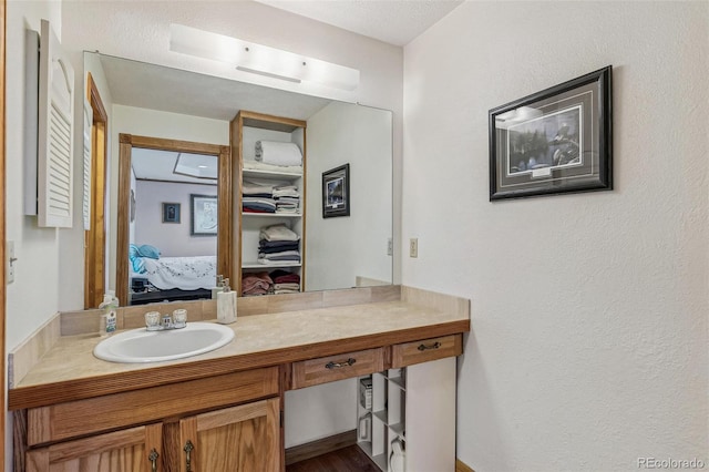 ensuite bathroom featuring connected bathroom and vanity