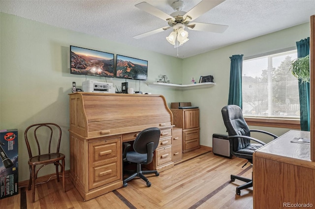 office space with light wood-type flooring, baseboards, a textured ceiling, and ceiling fan