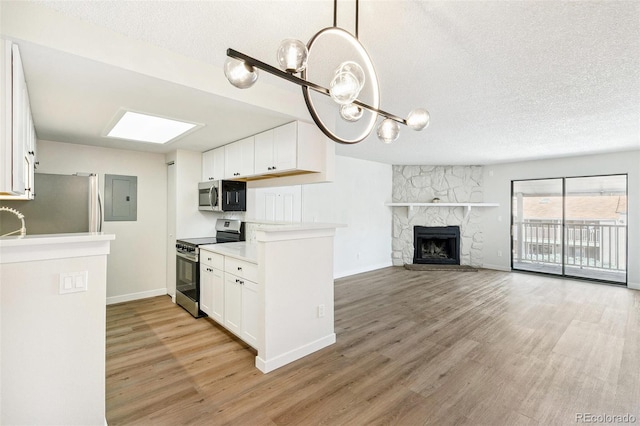 18302 E Kepner Pl Unit 207, Aurora, CO 80017 - kitchen featuring appliances with stainless steel finishes, electric panel, a textured ceiling, light wood-style floors, and white cabinetry