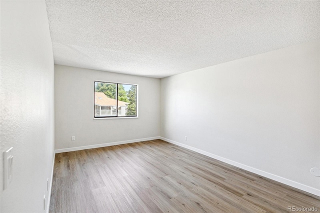 18302 E Kepner Pl Unit 207, Aurora, CO 80017 - unfurnished room with wood finished floors and a textured ceiling