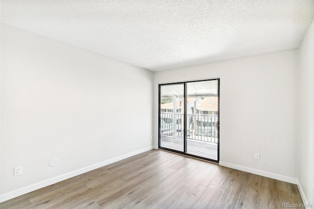 18302 E Kepner Pl Unit 207, Aurora, CO 80017 - empty room with wood finished floors and a textured ceiling