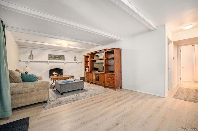 12289 W Atlantic Ave, Lakewood, CO 80228 - living room featuring beamed ceiling, wood finished floors, a brick fireplace, and baseboards