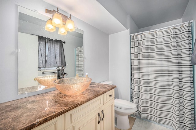12289 W Atlantic Ave, Lakewood, CO 80228 - bathroom featuring toilet, vanity, and a shower with shower curtain