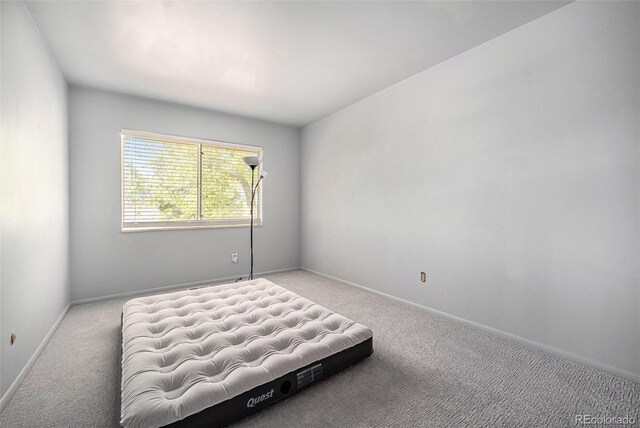 12289 W Atlantic Ave, Lakewood, CO 80228 - bedroom with carpet floors and baseboards