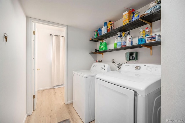 12289 W Atlantic Ave, Lakewood, CO 80228 - laundry area with light wood finished floors, independent washer and dryer, and baseboards