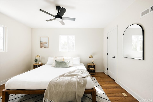 1219 Cherry St, Denver, CO 80220 - bedroom with dark wood-style flooring, visible vents, baseboards, and multiple windows