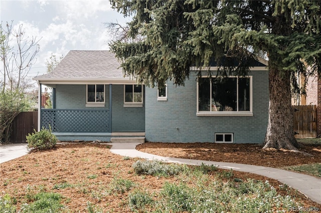 1219 Cherry St, Denver, CO 80220 - view of front of home featuring brick siding, fence, a porch, and roof with shingles