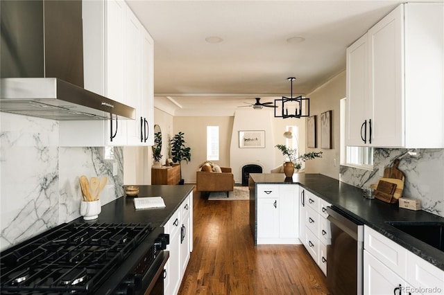 1219 Cherry St, Denver, CO 80220 - kitchen featuring dark countertops, wall chimney range hood, appliances with stainless steel finishes, and ceiling fan