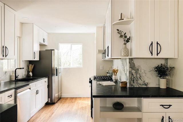 1219 Cherry St, Denver, CO 80220 - kitchen featuring decorative backsplash, appliances with stainless steel finishes, open shelves, and a sink