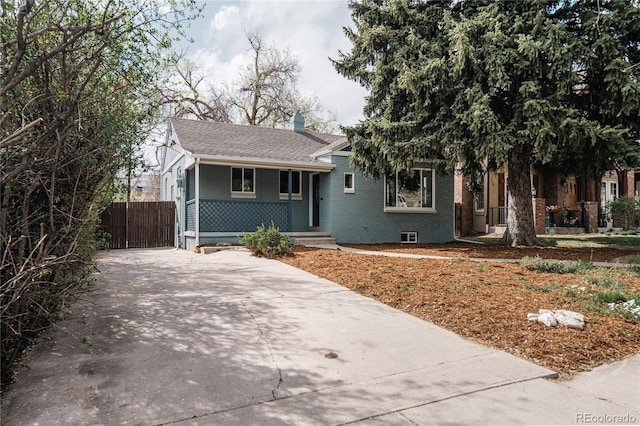 1219 Cherry St, Denver, CO 80220 - view of front of property with a chimney, a shingled roof, concrete driveway, a porch, and brick siding
