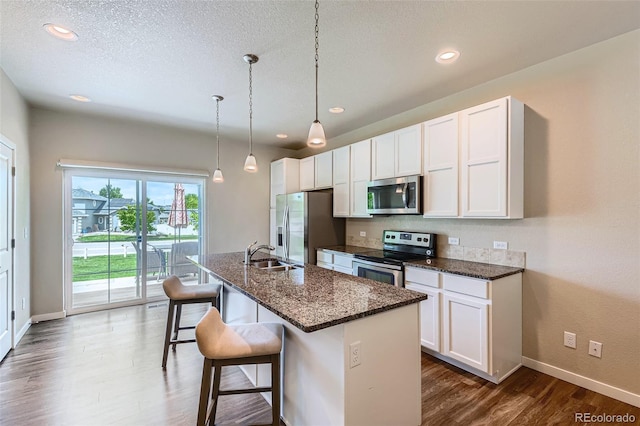 6024 W 1st St Unit 30, Greeley, CO 80634 - kitchen with stainless steel appliances, dark wood-style flooring, baseboards, white cabinetry, and recessed lighting