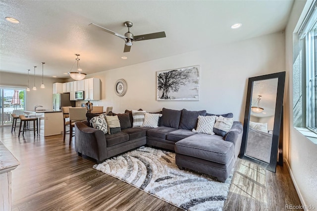 6024 W 1st St Unit 30, Greeley, CO 80634 - living area featuring dark wood-style floors, a ceiling fan, and recessed lighting