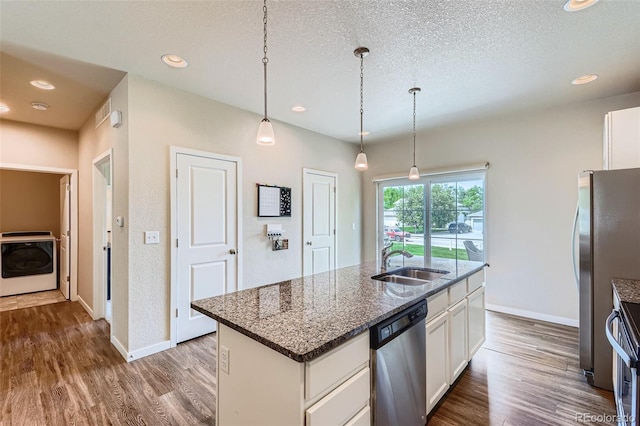6024 W 1st St Unit 30, Greeley, CO 80634 - kitchen featuring washer / dryer, stainless steel appliances, a sink, dark wood-style flooring, and a textured ceiling