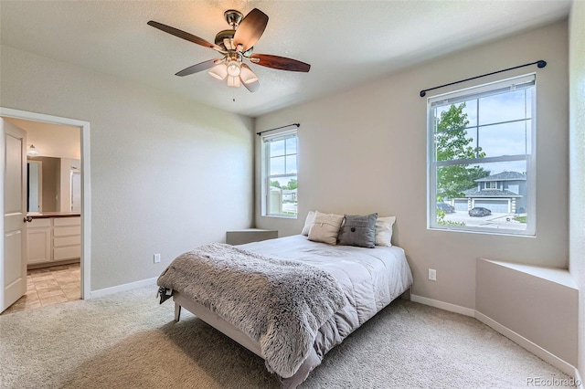 6024 W 1st St Unit 30, Greeley, CO 80634 - bedroom featuring light carpet, baseboards, ensuite bathroom, and ceiling fan