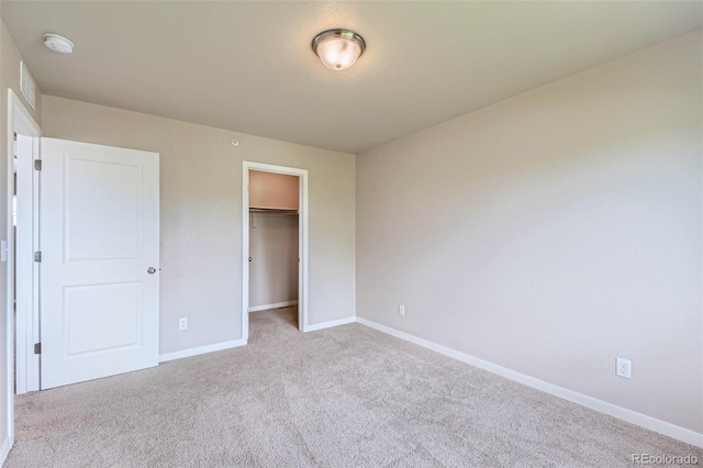 6024 W 1st St Unit 30, Greeley, CO 80634 - unfurnished bedroom with carpet flooring, baseboards, a walk in closet, and a closet