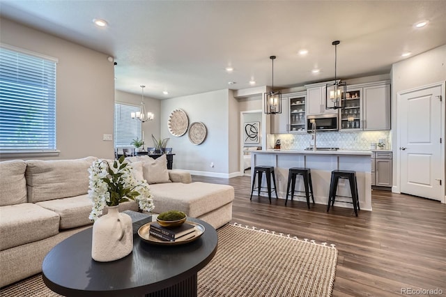 13460 Broad Wing Ave, Parker, CO 80134 - living room featuring recessed lighting, a chandelier, dark wood-style floors, and baseboards