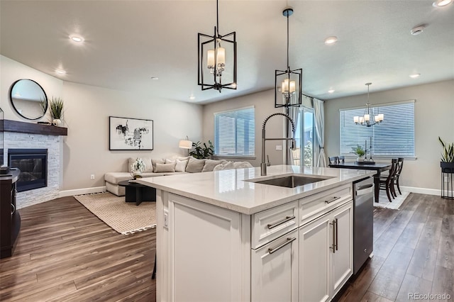 13460 Broad Wing Ave, Parker, CO 80134 - kitchen featuring a chandelier, a sink, open floor plan, dishwasher, and baseboards