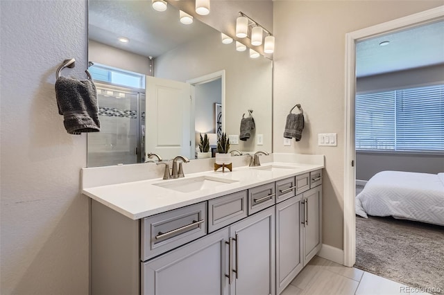 13460 Broad Wing Ave, Parker, CO 80134 - ensuite bathroom with double vanity, an enclosed shower, and baseboards