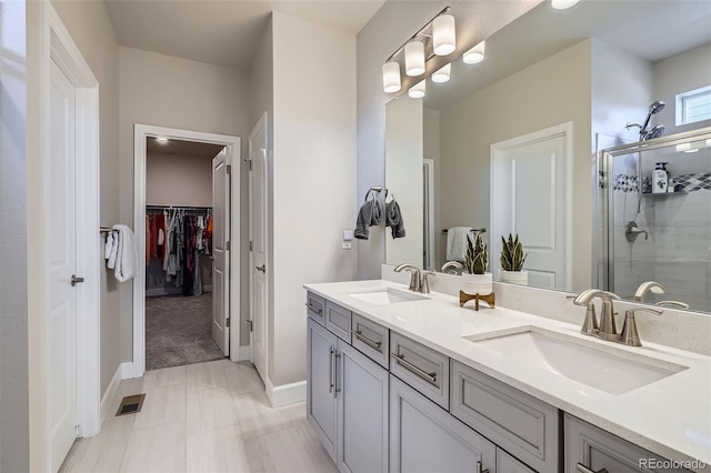 13460 Broad Wing Ave, Parker, CO 80134 - full bathroom featuring a stall shower, double vanity, a walk in closet, and baseboards