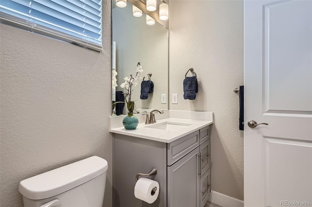 13460 Broad Wing Ave, Parker, CO 80134 - half bath with vanity, toilet, and a textured wall