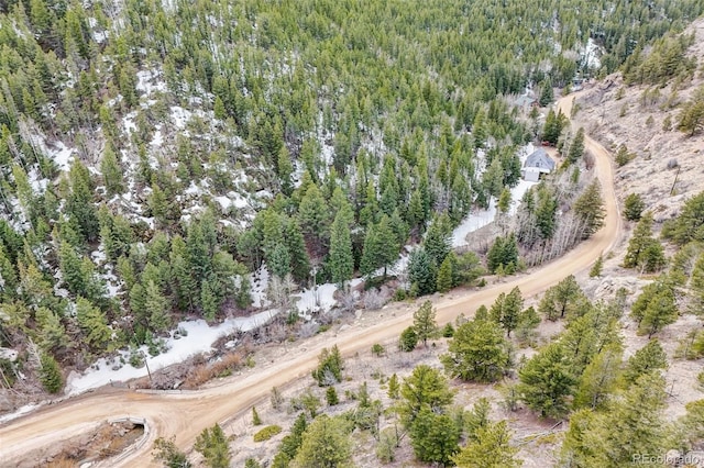 birds eye view of property with a forest view