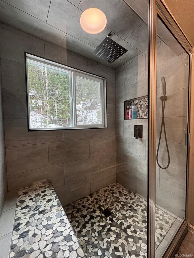 bathroom with a wealth of natural light and tiled shower