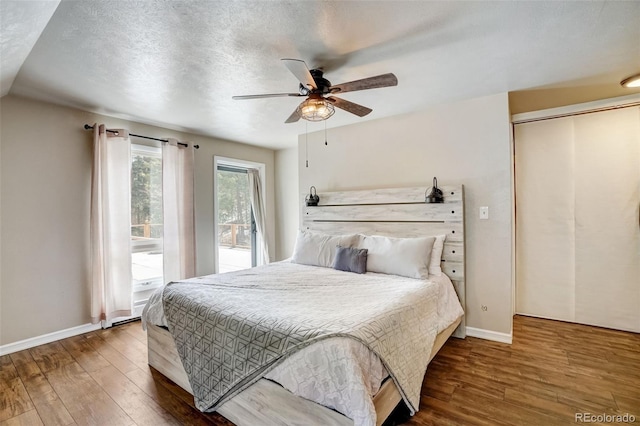 bedroom with ceiling fan, baseboards, and wood finished floors