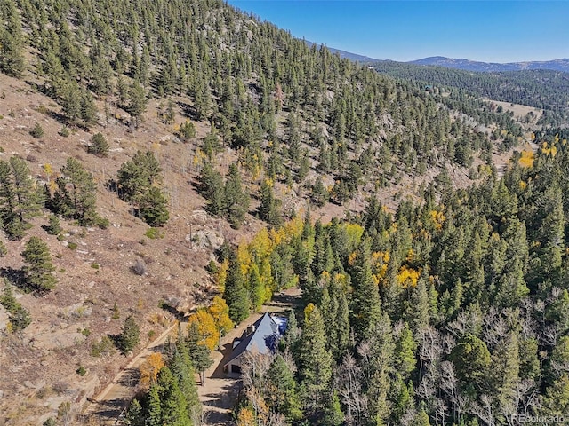 bird's eye view featuring a mountain view and a wooded view