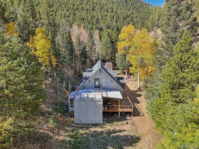 birds eye view of property with a wooded view