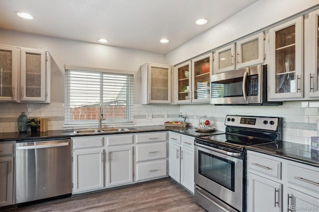 kitchen featuring dark hardwood / wood-style flooring, stainless steel appliances, white cabinetry, and sink