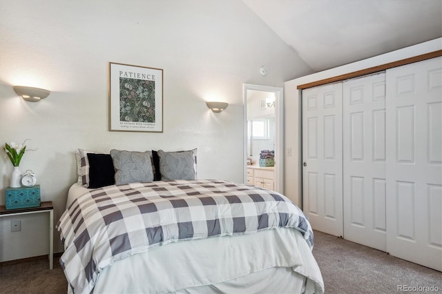 carpeted bedroom featuring ensuite bath, a closet, and vaulted ceiling