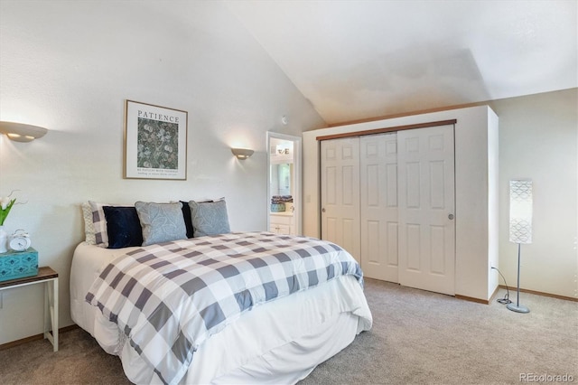 bedroom with lofted ceiling, carpet floors, and a closet