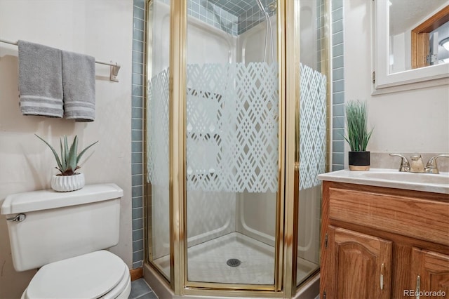 bathroom featuring an enclosed shower, vanity, and toilet