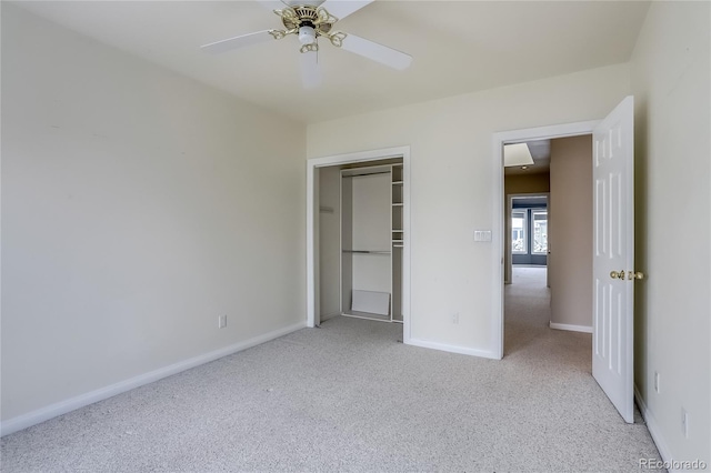 unfurnished bedroom featuring light colored carpet, a closet, and ceiling fan