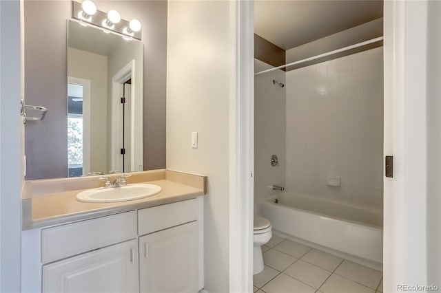 full bathroom with toilet, vanity, tiled shower / bath, and tile patterned flooring