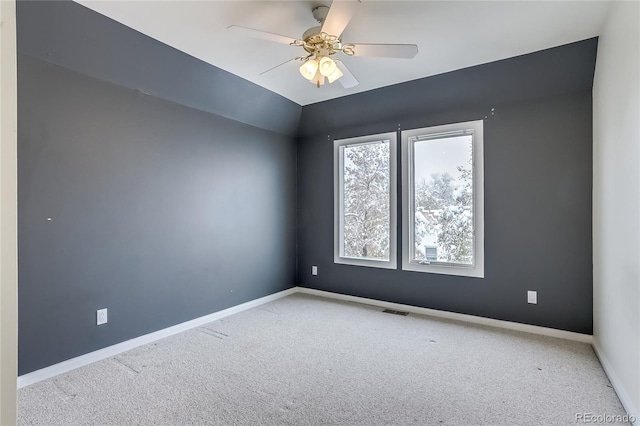 spare room with light carpet and ceiling fan