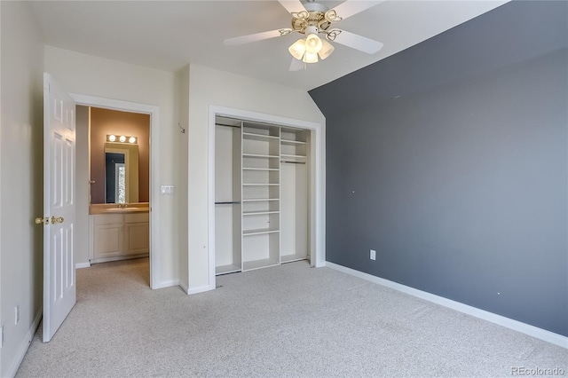 unfurnished bedroom featuring ceiling fan, light colored carpet, a closet, and sink