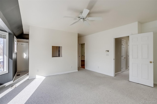 unfurnished bedroom featuring light carpet and ceiling fan