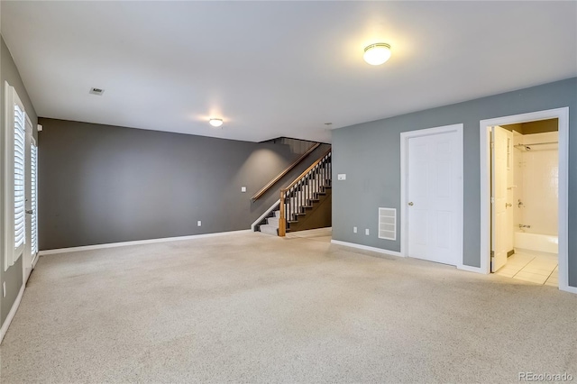 unfurnished living room featuring light colored carpet