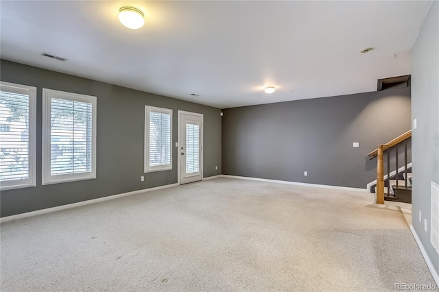 unfurnished living room with light carpet