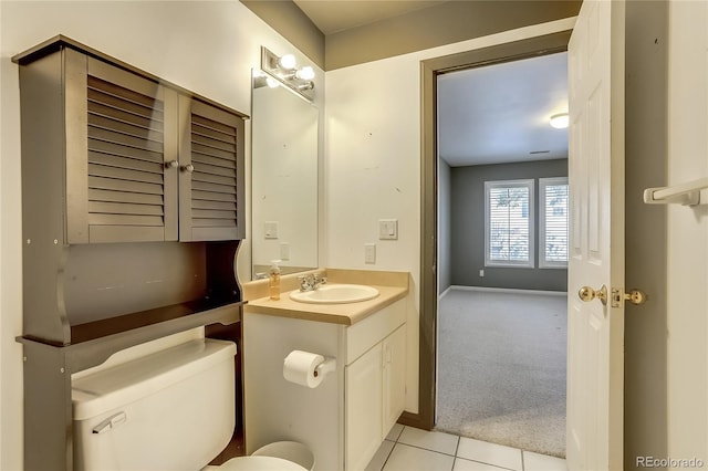 bathroom with toilet, tile patterned flooring, and vanity