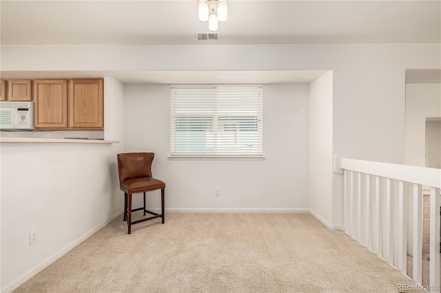 sitting room with light colored carpet