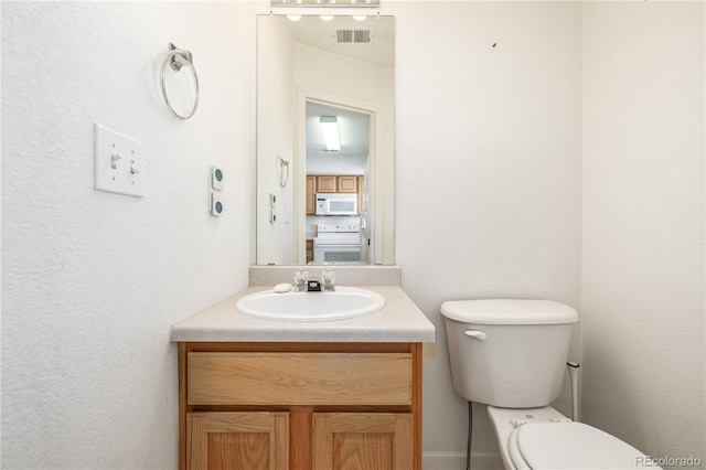 bathroom with vanity and toilet